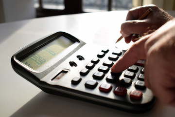 Obraz premium Businessperson working in office.Man hand with calculator at workplace