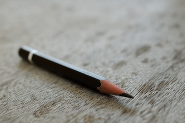  pencil placed on a wooden table old faded over time.