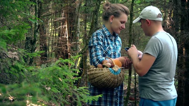 Upset couple man and woman try to find way out from forest with smartphone gps