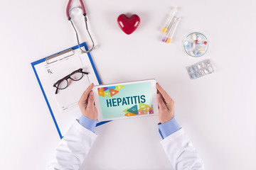 Doctor workplace with HEPATITIS on tablet