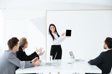 Woman showing blank tablet computer screen