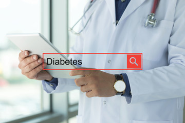 DOCTOR USING TABLET PC SEARCHING DIABETES ON WEB