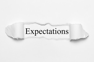 Obraz premium Expectations on white torn paper