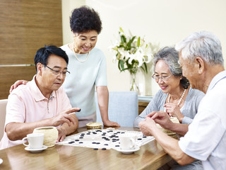 Senior people playing Weiqi at home
