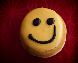 Smiley doughnut with lemon cream icing and chocolate 