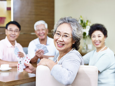 senior asian woman in  card game