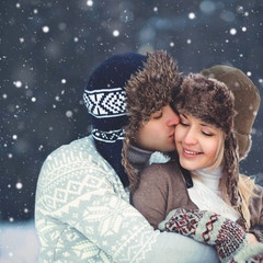 Portrait happy young couple in love at winter day, man gentle ki