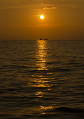 sunset on the lake with a boat on the horizon