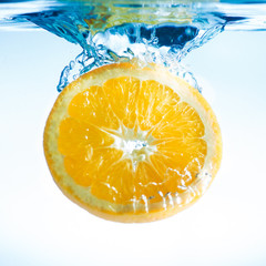 orange slice fruit splashing, focus on splashes