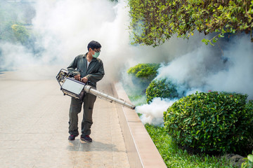 Man work fogging to eliminate mosquito for preventing spread dengue fever and zika virus