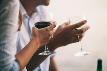 couple drink wine at sunset beach