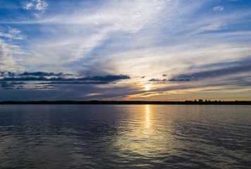 Fototapeta premium Sunset sky background. Dramatic gold sunset sky with evening sky clouds over the sea. Stunning sky clouds in the sunset. Sky landscape. 