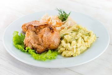 Russian homemade dish: mashed potatoes, chicken and cabbage sala