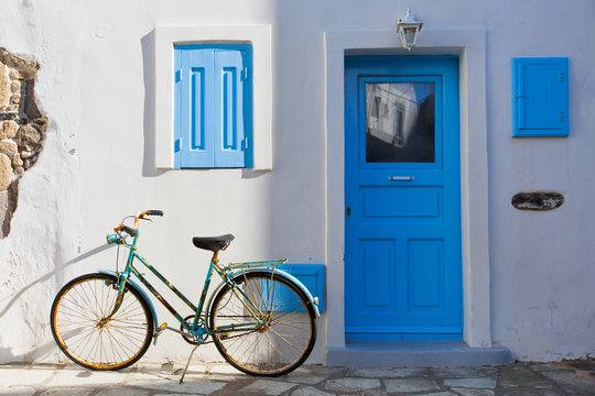 Old bicycle in front of a traditional house in Mandraki village on Nisyros island.