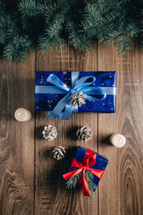 New Year composition View from above. Herringbone toys with candles, boxes on wooden background