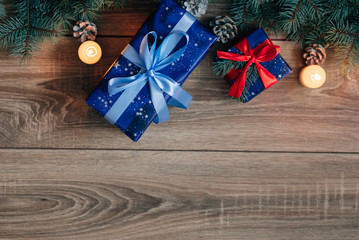 New Year composition View from above. Herringbone toys with candles, boxes on wooden background