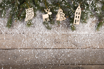christmas decorations with snow on the wooden background