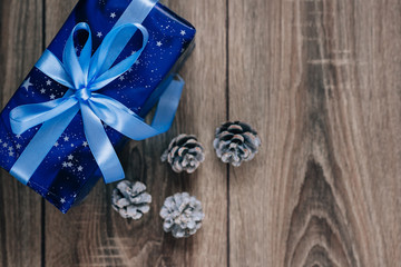 Gift box and a cone on  Christmas background