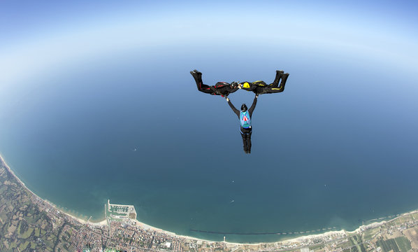Skydive 3D formation over sea