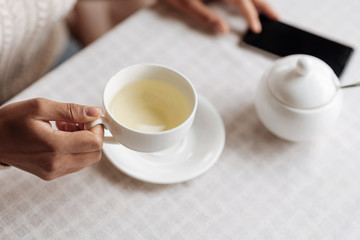 Young African American woman holding the cup of tea