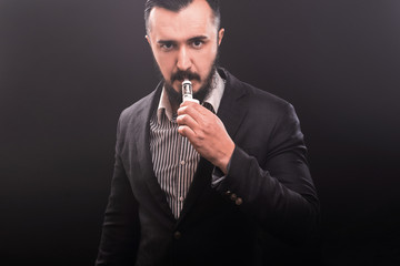 vaping man holding a mod. A cloud of vapor.