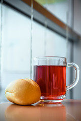 Cup with compote on a table and fresh bread