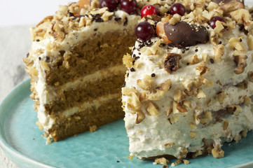 Carrot cake with cream cheese, nuts, berries and tangerines