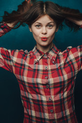 Pretty red-haired woman on a blue background
