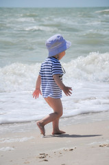 two-year-old boy run on the beach