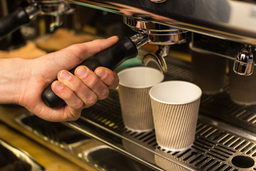 Barista making fresh takeaway coffee.