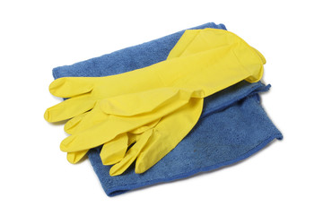 Protective rubber gloves and cleaning products on white background