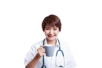 Young Asian female doctor hold a mug and smile.