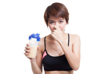 Beautiful Asian healthy girl hate whey protein smell.