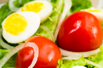 Blurred image of cherry tomatoes in a salad