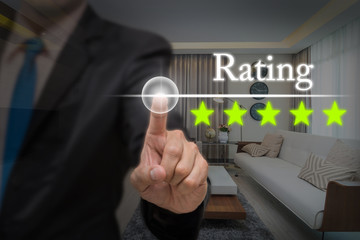Businessman pointing five star button to increase rating of hote