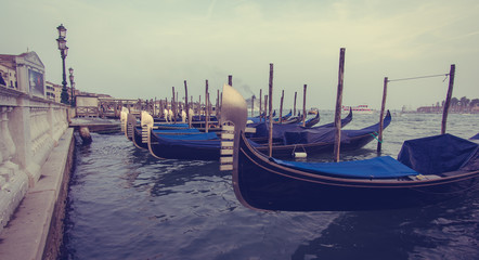 Fototapeta na wymiar Canal with gondolas in Venice, Italy (Vintage Style)