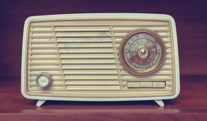 Old radio on wooden background