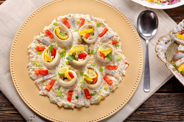Rolled herrings with fish salad and lemon