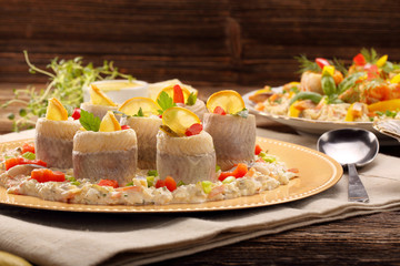 Rolled herrings with fish salad and lemon