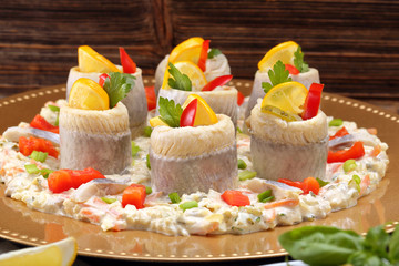 Rolled herrings with fish salad and lemon