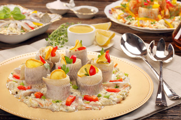 Rolled herrings with fish salad and lemon