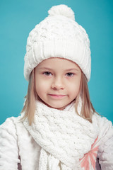 portrait of a little  girl in white hat and scarf 