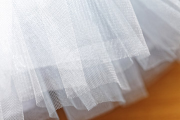 Macro view of sewing dresses. Close Up of fabric mesh for Tutu. Children's dance skirt. Net wedding...