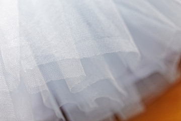 Macro view of sewing dresses. Close Up of fabric mesh for Tutu. Children's dance skirt. Net wedding textile.