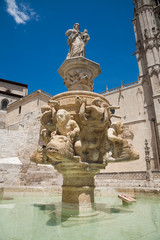 Fototapeta na wymiar sculpture in fountain next to facade landmark of famous gothic catholic cathedral St Mary or Santa Maria, monument from XIII Century, in Burgos city, Castile, Spain Europe 