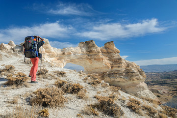 Backpacker take photo large holes in Cappadocia