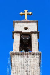 Church bells and tower with golden cross