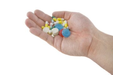 Closeup of vitamins and pills in human hands isolated over white