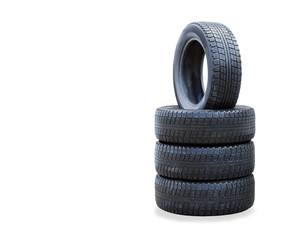 The stack of four winter new tires over white - obrazy, fototapety, plakaty