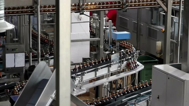 Plastic water bottles on conveyor or water bottling machine 